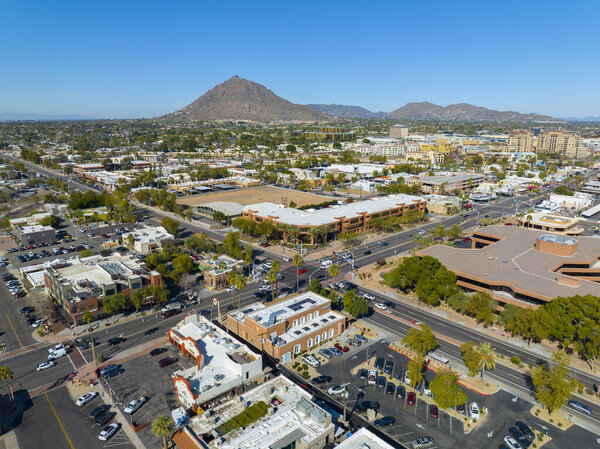 Scottsdale city center aerial view on Scottsdale Road at Indian School Road with Camelback Mountain at the background in city of Scottsdale, Arizona AZ, USA.