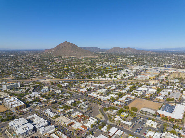 Scottsdale city center aerial view on Scottsdale Road at Main Street with Camelback Mountain at the background in city of Scottsdale, Arizona AZ, USA.
