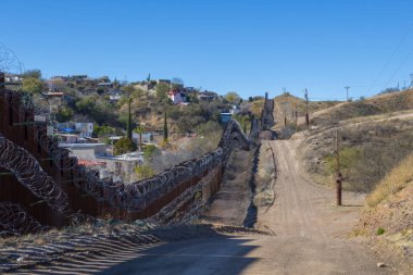 United States Mexico Border Wall between Nogales Arizona and Nogales Sonora on International Street in city of Nogales, Arizona AZ, USA. 