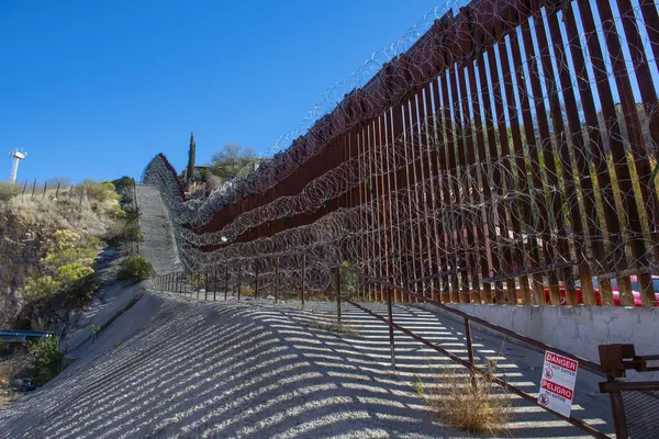 United States Mexico Border Wall between Nogales Arizona and Nogales Sonora on International Street in city of Nogales, Arizona AZ, USA. 