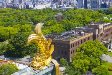 Osaka Castle Shachihoko (sea monster) on main keep roof. Osaka Castle is a Japanese castle in Chuo ward in historic city of Osaka, Japan. It's one of the most famous castle in Japan.  clipart