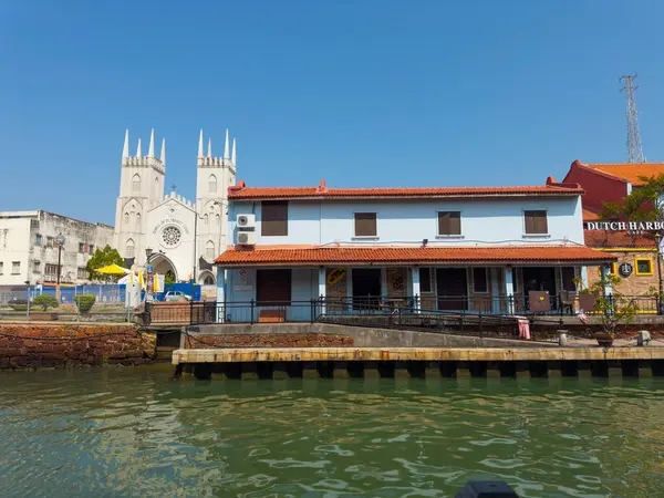 stock image Church of St. Francis Xavier Melaka and waterfront house on Malacca River in city center of Melaka, Malaysia. Historic cities of the Strait of Malacca is a World Heritage Site. 