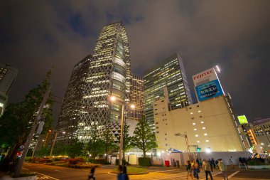 Mode Gakuen Cocoon Tower and Shinjuku bus station at night in Shinjuku City, Tokyo, Japan.  clipart