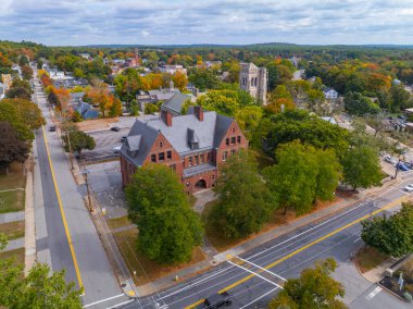 Aldrich School aerial view at 14 Hill Street in fall with foliage in historic village of Whitinsville, town of Northbridge, Massachusetts MA, USA.  clipart