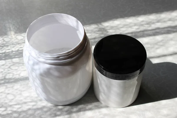 Two White Gray Plastic Jars Cleaning Gray Background — Stock Photo, Image