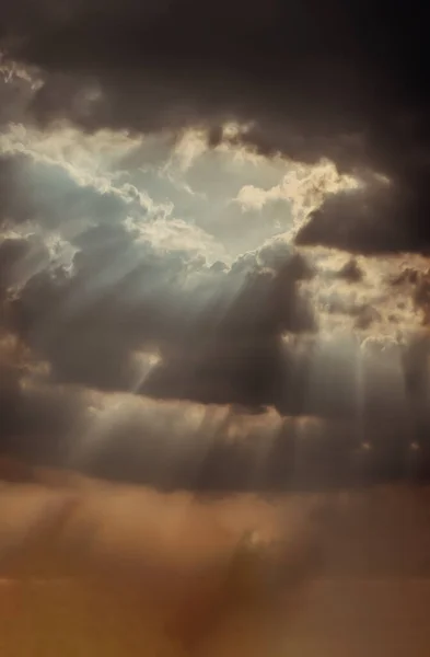 Stock image The sun's rays passing through the clouds and shining form an interesting light pattern against the sky. Space for text, Selective focus.