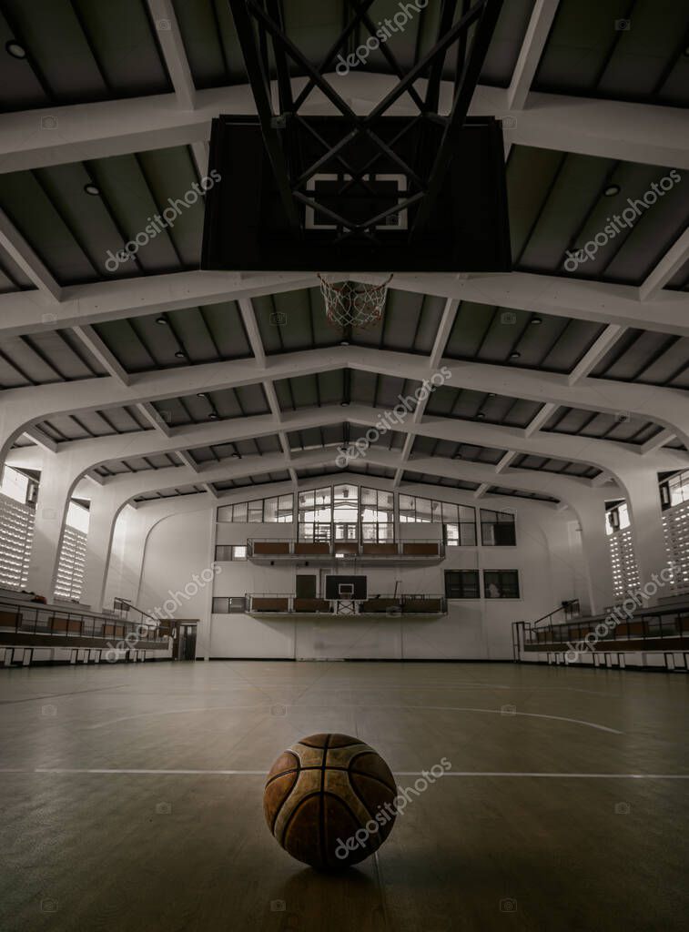 Bangkok, Tailandia - 27 de noviembre de 2022: Balón de baloncesto colocado  en el suelo de la cancha en el gimnasio de baloncesto. Vista desde Gimnasio  de baloncesto vacío, Espacio para texto,