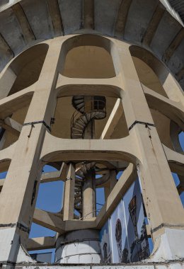 Bangkok, Thailand - 09 Feb, 2023 - View of columnar structures old water tower made of cement and metal spiral staircase. Large water tank in the water supply system. Selective focus.
