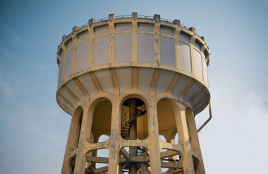 Bangkok, Thailand - 09 Feb, 2023 - An old water tower made of cement and metal spiral staircase is an elevated structure supporting a water tank constructed by The influence European architecture and considered one of the historic building in Bangkok