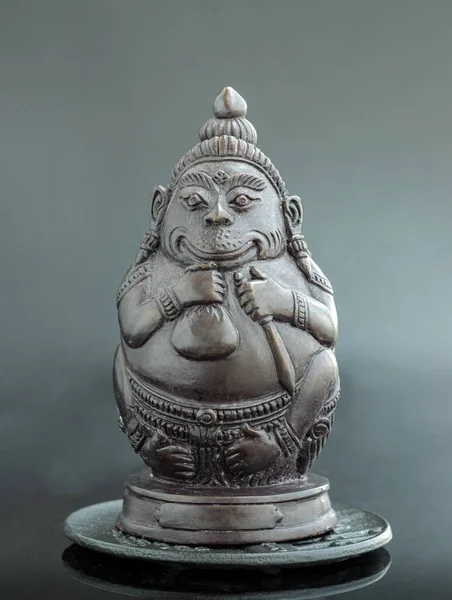 Figurine of Phali, (The Unbeatable Money King) Sculpture Statue on Dark Background. In Ramayana, Phali is the strongest monkey king who got blessing from God Shiva. Space for text.