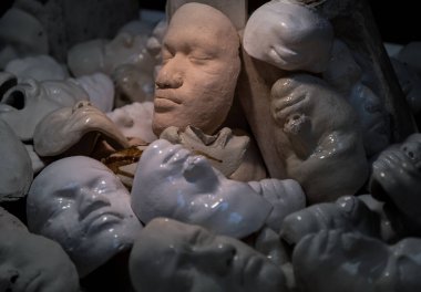 Bangkok, Thailand - 15 May 2022 : Heap of Human face masks made of plaster. image for horror, fear concept, Selective Focus.