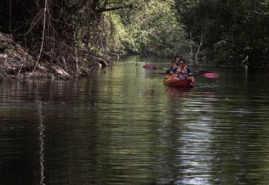 Nakhon Ratchasima, Tayland. Mar - 20, 2022: İki maceraperest kadın ormanda kırmızı kayak yaparken birlikte eğleniyorlar. Boş zamanlarımızda, doğa ve turistik aktivitelerde eğleniyoruz. Tam olarak odaklanamıyorum..
