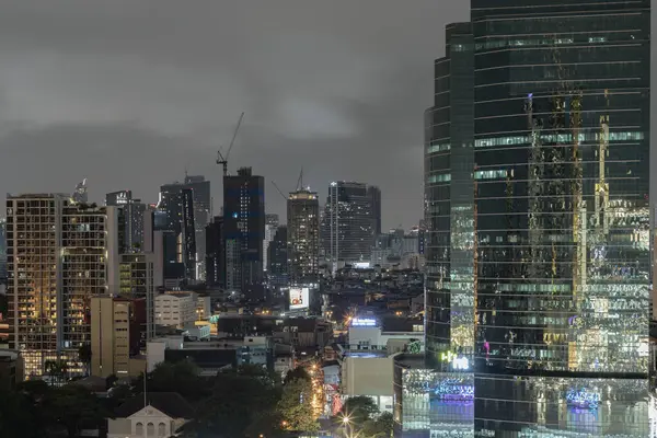 Stock image Bangkok, thailand - Aug 22, 2022 : Skyscrapers in the business district of Bangkok city at night under Sprinkling rain. Rainy season, No focus, specifically.