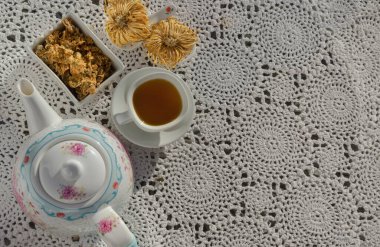 Çin kasımpatı çiçeği çayı ve kurutulmuş kasımpatı çiçeği örgü pamuklu keten masa minderinde. İçki için sağlıklı bir içecek. Bitkiler ve tıbbi konsept. Metin için boşluk, Seçici odak.