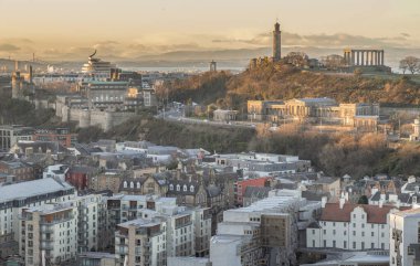 Edinburgh, İskoçya - 17 Ocak 2024 - İnanılmaz Edinburgh şehir manzarası ve Salisbury Kayalıkları 'nın tepesinden görünen ufuk çizgisi ile Calton Tepesi. Avrupa 'da azalma, metin için boşluk, seçici odaklanma.