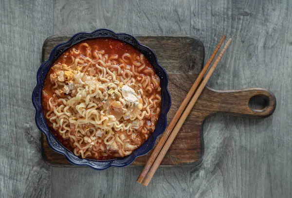 Yumurta ve seramik kasede arpacık soğanı ve tahta kesme tahtasının üzerinde baharatlı Tom yum eriştesi. Kolay şehriye yemeği, Top view, metin için alan, seçici odaklanma.