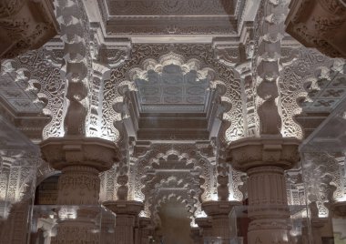 London, UK - Feb 27, 2024 - The Shree Sanatan Hindu Mandir Hindu temple interior architecture with view of intricately carved stone and columns with beautiful artwork. Inside the Shri Sanatan Hindu Temple, Space for text, Selective focus. clipart