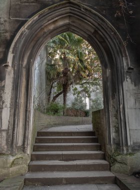 Londra, İngiltere - 27 Şubat 2024 - Taştan kemerli giriş, St. Dunstan 'ın Doğu Kilise Bahçesi' ndeki taş merdivenlere çıkıyor. Tarihi kilise İkinci Dünya Savaşı 'nda bombalandı ve yok edildi ve şimdi bir park, Londra' nın gizli yerleri, Spac