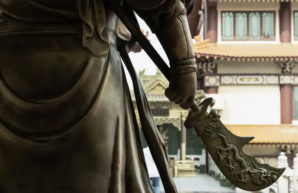 stock image Bangkok, Thailand - Apr 11, 2024 - Green dragon crescent blade (Halberd) weapon of Sangharama Bodhisattva (Buddhist deity). Sangharama deity at Fo Guang Shan Thaihua Temple, Space for text, Selective focus.