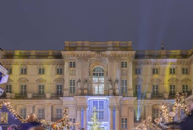 Berlin, Germany - Dec 19, 2023 - The Festive illumination of the palace facade at night. A Christmas market held in large courtyard of the restored Berlin Palace (Berliner Schloss) also known as Humboldt Forum Located on Schlossplatz (museum dedicate clipart