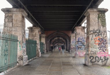Berlin, Germany - Dec 19, 2023 - View of Under Oberbaum Bridge over the Spree River in Berlin. East arcades, One of the most important bridges in Berlin. Space for text, Selective focus. clipart