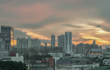 Bangkok, Tayland - 20 Mayıs 2024 - Metropolitan şehri üzerinde güzel bulutlar ve gökyüzü ile gün batımının muhteşem manzarası. Gün batımından sonra Bangkok gökdelenleri güzel bir gökyüzü arkaplanı ile Duvar kağıdı, Kopyalama alanı ve Seçici Odaklanma olarak kullanılabilir..