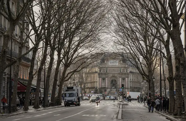 stock image France, Paris - Jan 03, 2024 - Street view and Old building design of The Fontaine Saint-Michel in City of Paris. Traffic on the road with cars and people, Space for text, Selective focus.