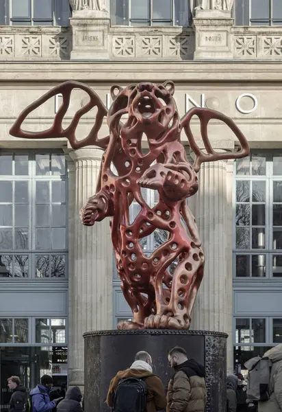 stock image France, Paris - Jan 05, 2024 - View of the Angel Bear red sculpture made (A piece of contemporary art) by the artist Richard Texier in front of the main Gare du Nord or Paris train station.