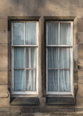 Edinburgh, Scotland - Jan 19, 2024 - The sunshine lights through the glass window frame exterior of old house. Glass window and old wall in Edinburgh, Space for text, Selective focus. clipart