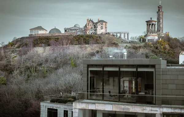 stock image Edinburgh, Scotland - Jan 19, 2024 - View of Calton Hill with the skyline seen from the top of St James Quarter shopping centre in Edinburgh city. Destinations in Europe, Space for text, Selective focus.