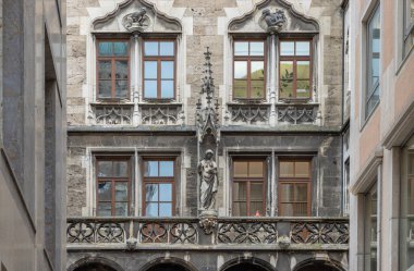 Munich, Germany - Dec 21, 2023 - Sandstone Building with many Windows is Decorated with Statues with Gothic style. Exterior architecture design of famous New Town Hall (Neue Rathaus) on Marienplatz square in Munich, Space for text, Selective focus. clipart