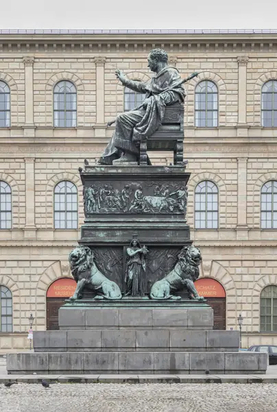 stock image Munich, Germany - Dec 21, 2023 - Side view of Monument Bronze Statue of King Maximilian I Joseph of Bavaria with The Munich Residence Museum Building at the Max Joseph Square in central Munich. Space for text, Selective focus.