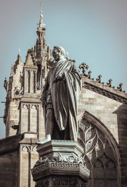 Edinburgh, Scotland - Jan 18, 2024 - Statue of Walter Francis Montagu Douglas Scott (Duke of Buccleuch) in front of St Giles' Cathedral or the High Kirk of Edinburgh. Space for text, Selective focus. clipart