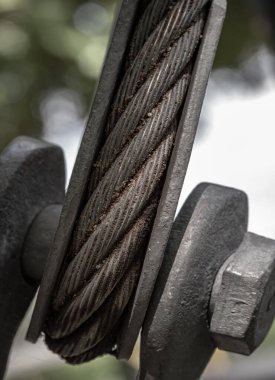 Close-up of Steel wire rope slings with Thimble and safety anchor shackle turnbuckle connection bolt for heavy work. Device for adjusting the tension or length cable, Metal ring and Steel cabling attached to a shackle, Space for text, Selective Focus clipart