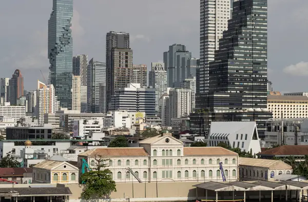 stock image Bangkok, Thailand - 28 Sep, 2024 - Exterior view of The old customs house Or Old bang rak fire station building with Skyscrapers background. Architectural View of Old and New Buildings in Contrasting Classical and Modern Designs, S