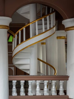 Bangkok, Tayland - 07 Aralık 2024 Safirusslam Camii 'ndeki korkuluk binalarının içindeki sarmal merdiven dekorasyonu. Beyaz spiral merdiven desenlerinin yan görünüşü altın beyazı parmaklıklardan yapılmıştır.