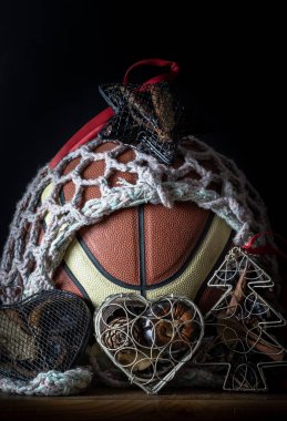 İçinde ağ örgüsü süslemesi olan basketbol topu, Noel ağacı örgüsü davası, ve karanlık arka planda Star Ağ davası. Noel temalı basketbol fikri, Noel 'de spor oyunu, Duvar kağıdı, Poster ve Uzay olarak kullanın..