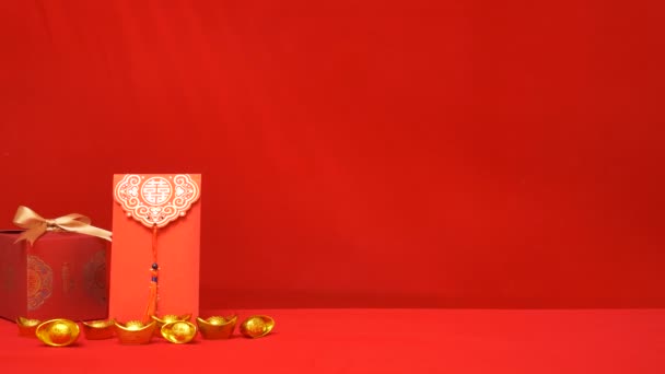 中国の旧正月の赤い背景のループ 古代中国の金棒 黄金の弓 赤い封筒 中国の新年のお祝いにお金を与えるための怒りの力 影の葉の揺れ — ストック動画