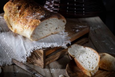 Kırsal masada ev yapımı taze ekmek dilimlenmiş.