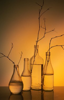 Sarı arkaplanda cam şişeler