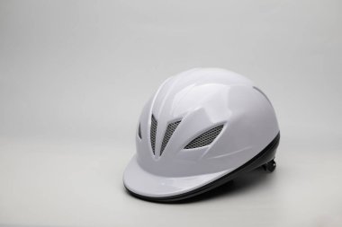 White plastic helmet for equestrian dressage isolated on white background