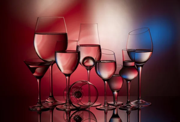 Nine Glass Goblets Colorful Gradient Background — стоковое фото