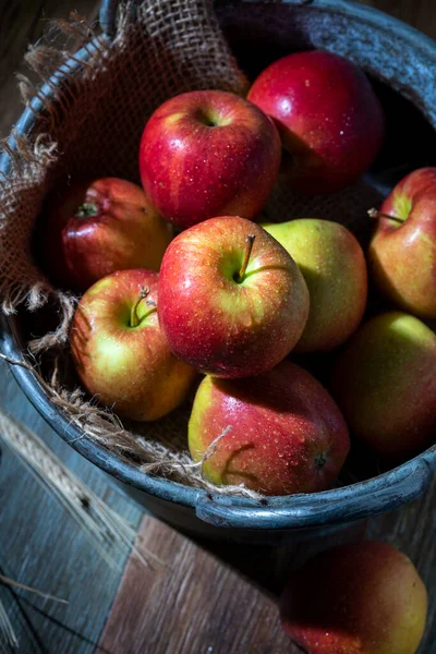 stock image Red apples in a metal bowl on a wooden table