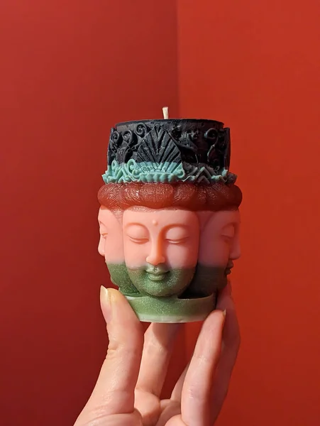 Kırmızı Zemin Üzerinde Buda Şeklinde Dekoratif Yapımı Mum Yakın Plan — Stok fotoğraf