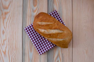 Dilimlenmemiş taze kepekli ekmek somunu ahşap masada