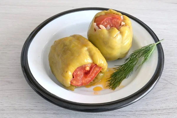 Presentation of stuffed peppers on a white plate