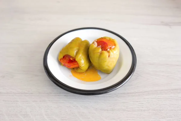 Presentation of stuffed peppers on a white plate