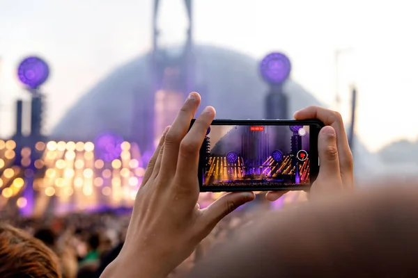 Taking photos of a rock concert on the mobile phone, open-air festival