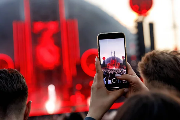 Taking photos of a rock concert on the mobile phone, open-air festival