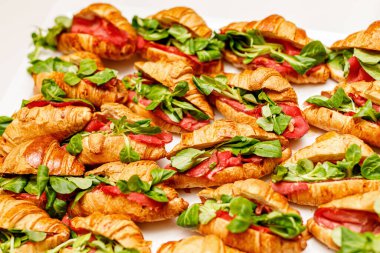 Croissant with basil, prosciutto, and mozzarella fillings. Top view